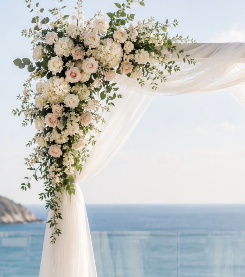 Tulle draping and artificial floral arrangements on a wedding arch